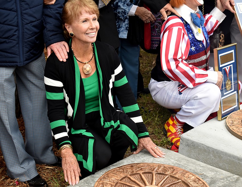 Ilona Fullgrap, part of inductee group The Fredonias poses next to their plaque.