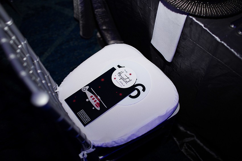 A program and paddle for the paddle raise was placed on each attendee's chair.