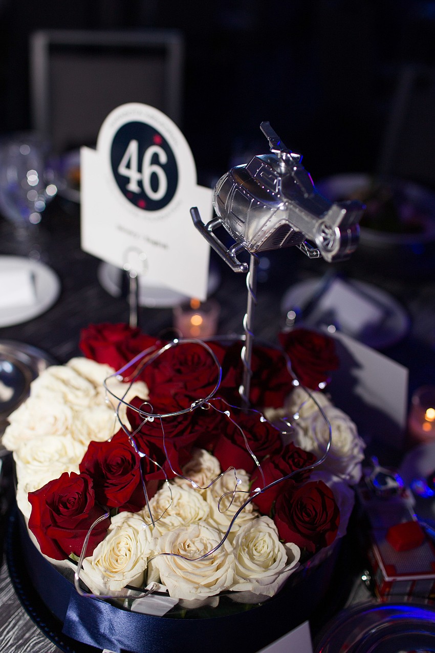 Each table had a centerpiece made of roses to look like a landing pad topped with a helicopter.