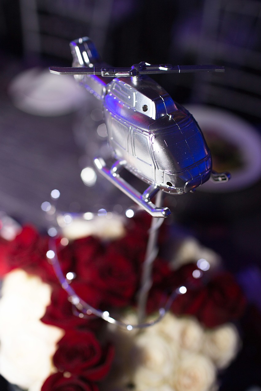A metal helicopter was the centerpiece of each table.