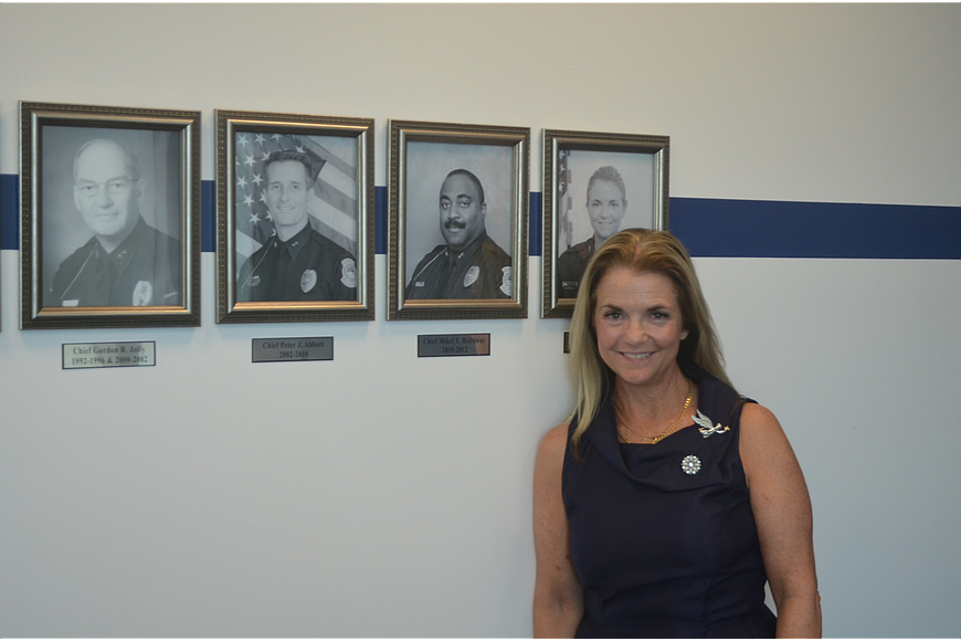 Sarasota Police Chief Bernadette DiPino stands alongside photos of the city&#39;s previous chiefs. She is the first female to lead the department.