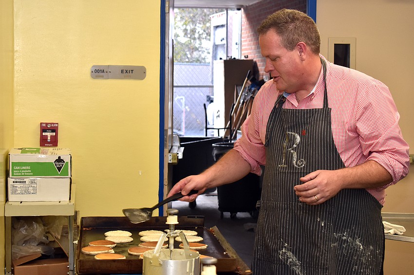 Gocio Principal Steve Royce flips pancakes for the Principal’s Breakfast.