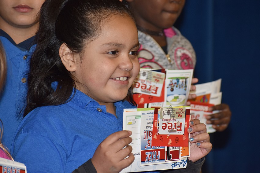 Students show off their coupons and certificate during the breakfast.