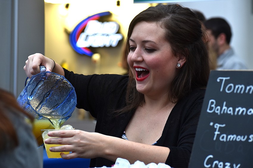 Cassie Gilmore pours a glass of Tommy Bahama’s “Crazy Cuban” cocktail.