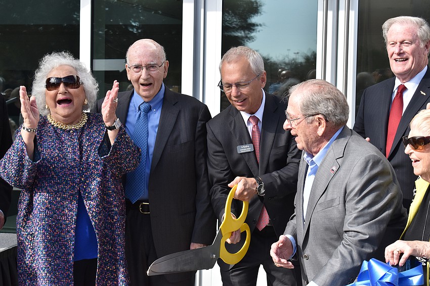 Nancy and Phil Kotler, Steven High, Warren Coville, John Thraser and Margot Coville rejoice after the ribbon is officially cut.