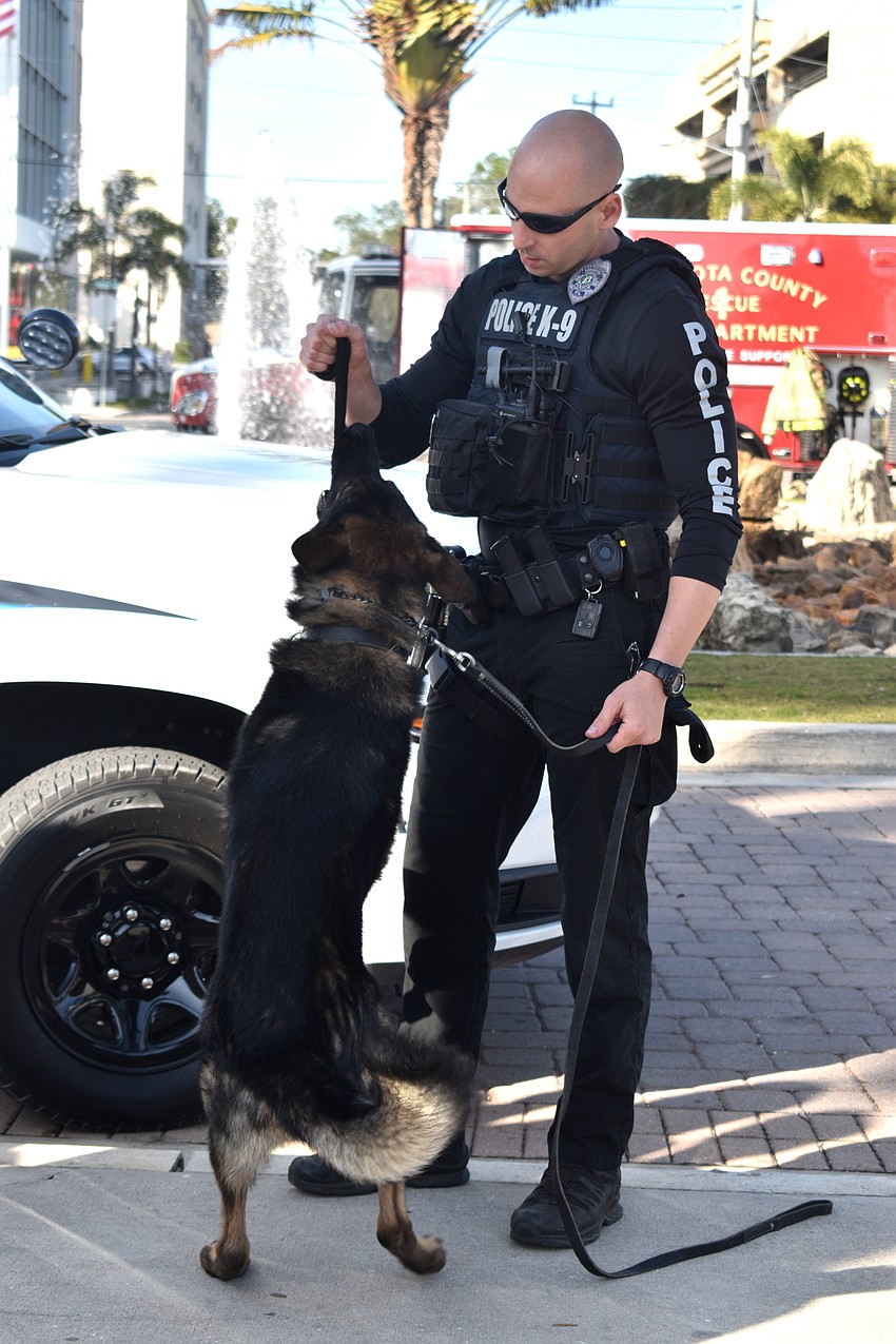 Police Officer Jake Nelson plays with Bronson.