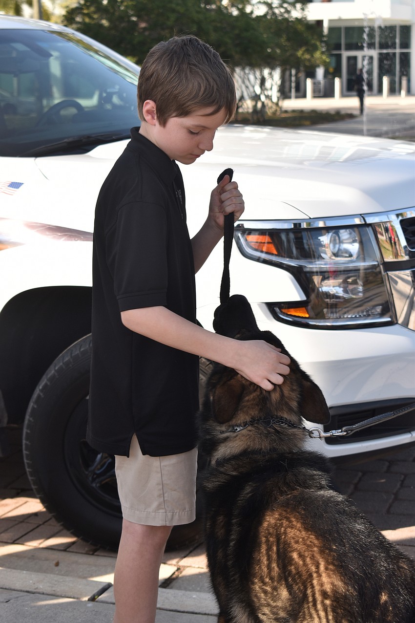 Joshua Block of Sarasota School of Arts and Sciences gives Bronson a pet.
