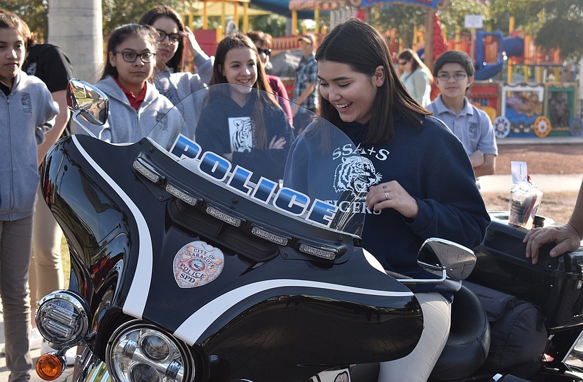 Isabella Moreno takes a seat on a Sarasota Police Department motorcycle.