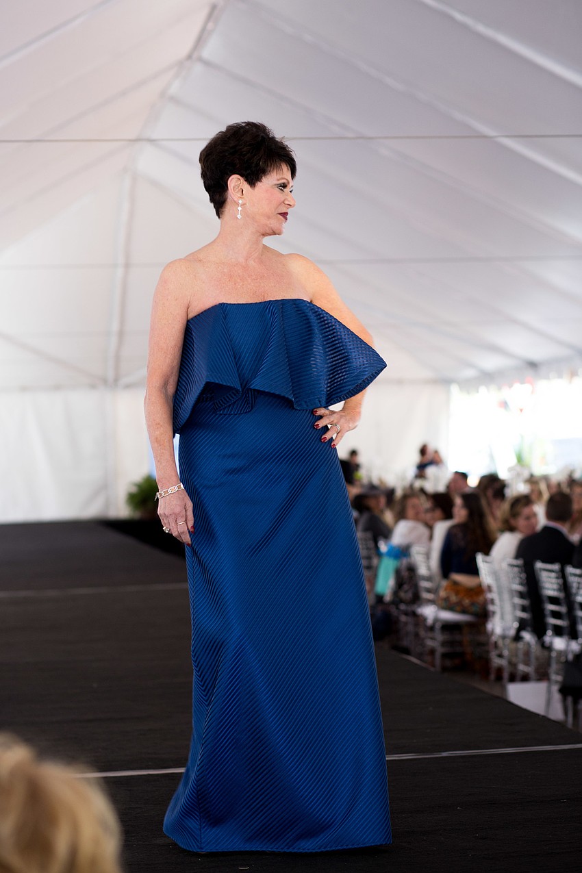 Wendy pauses at the end of the stage to show off the first dress.