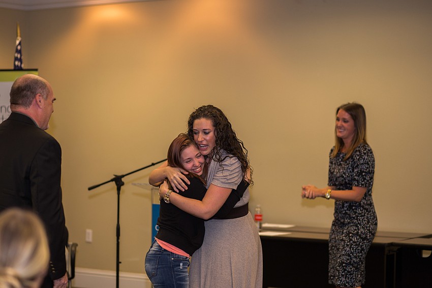 Designing Daughters President Elli Baldwin hugs Felicity, a survivor of child sex abuse and representative of More Too Life.