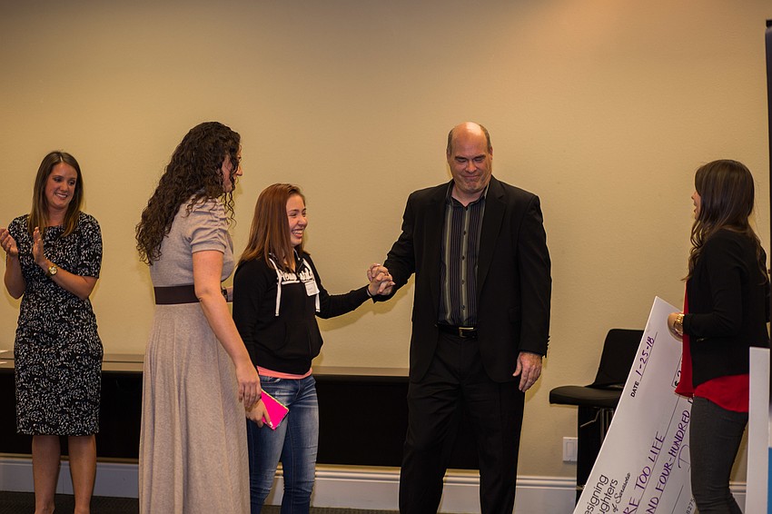 Felicity and Chris Hill receive the check for More Too Life.