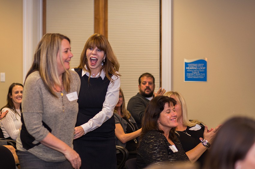 SPARCC leaders jump for joy as they collect the $3,400 check for their organization.