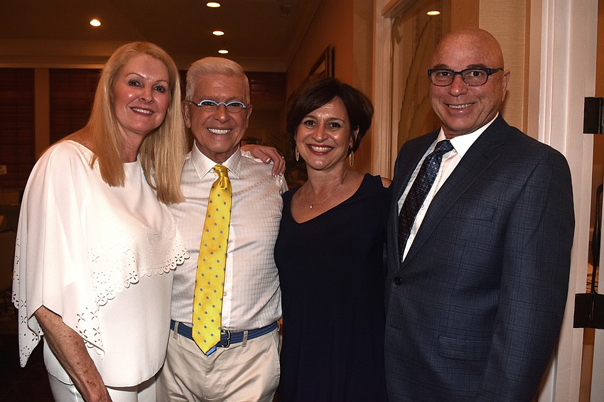 Longboat Key Garden Club President Susan Phillips, event emcee Bob Trisolini and Island Pursuit owners Lori and Michael Valentino