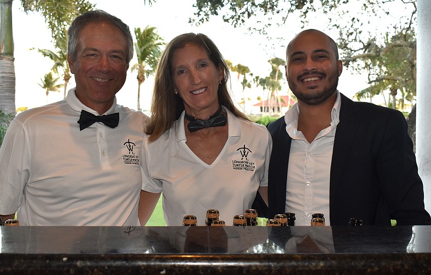 “The Turtle People” bartenders Longboat Key Turtle Watch President Tim Thurman, Vice President Cyndi Seamon and Jhon Zamora
