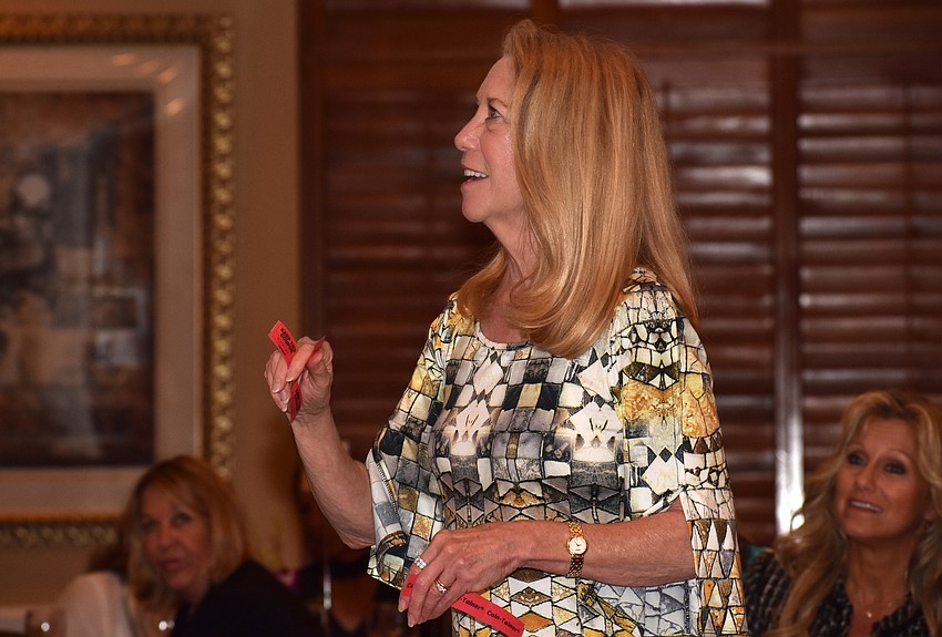 Ronnie Tobin shows off her raffle-winning ticket.