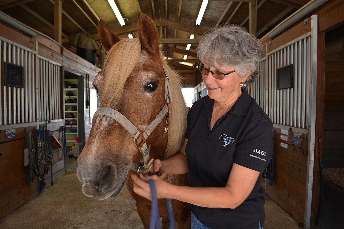 Gail Clifton prepares Carly for a riding lesson at SMART.
