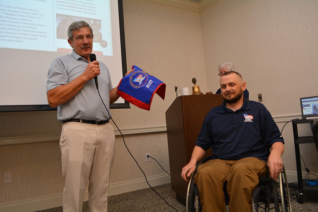 Rotarian Don Weippert chokes up while accepting thanks from veteran Carl Moore, whose Home for Our Troops homes was made partially possibly by Weippert&#39;s $10,000 donation. Weippert challenged his colleagues to support veterans.