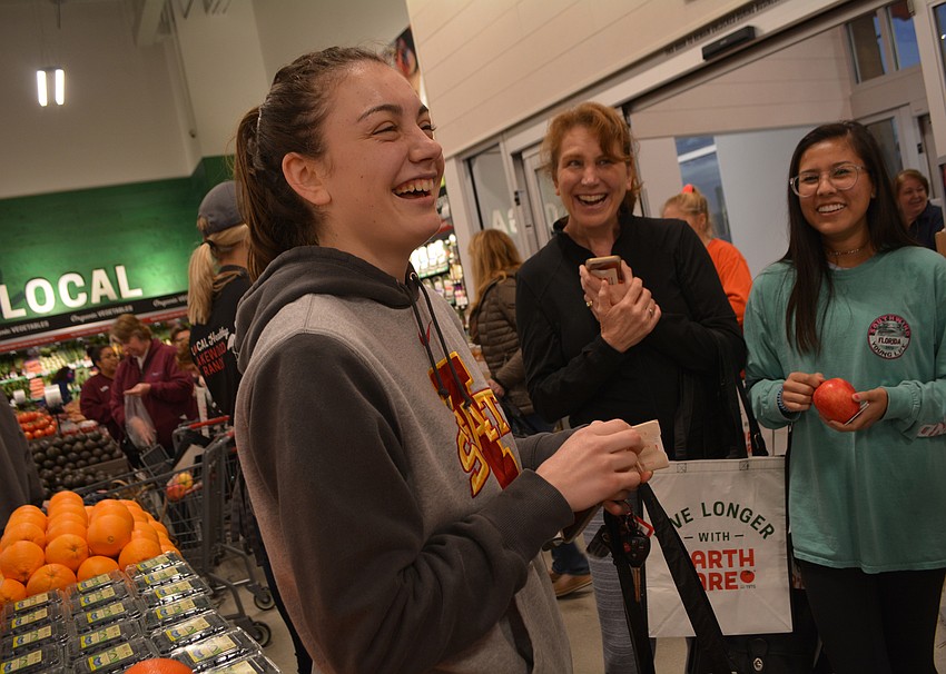Braden Woods resident Rebekah Lang, 18, is all smiles after winning the $1,000 gift card. She came out for the grand opening with her mom, Susan Lang, and friend, Charleen Krajcsik.