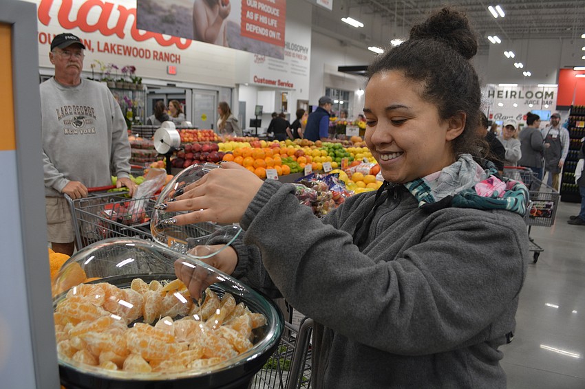 Sara Sanches, of River Plantation, gets an orange sample.