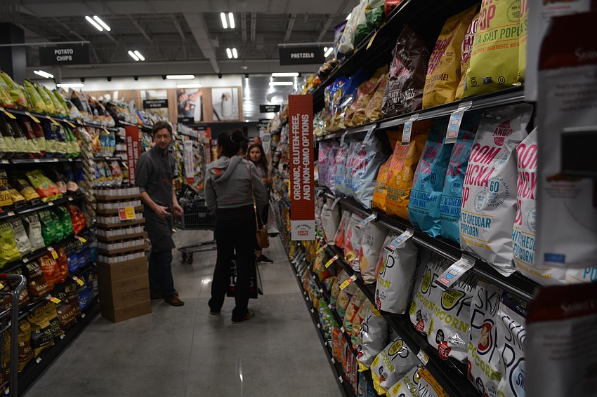 Guests perused isles of chips, cereals, detergents and other products.