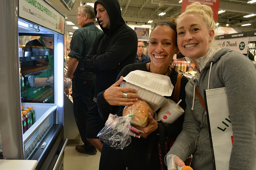 Sandy Wompey and Gretchen George, of Parrish, scope out the mineral juice shots after grabbing some pre-made food.