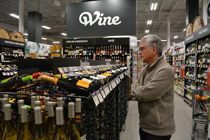 The Inlets resident Francis Poux scopes out the wine selection.