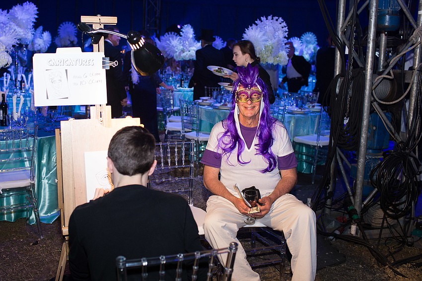 Steve Koenig gets his caricature drawn by Michael White.