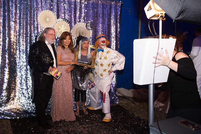 Bob Collins, Jiselle Stolper, Noriko and Chuck Sidlow get their photo taken at the photo booth.