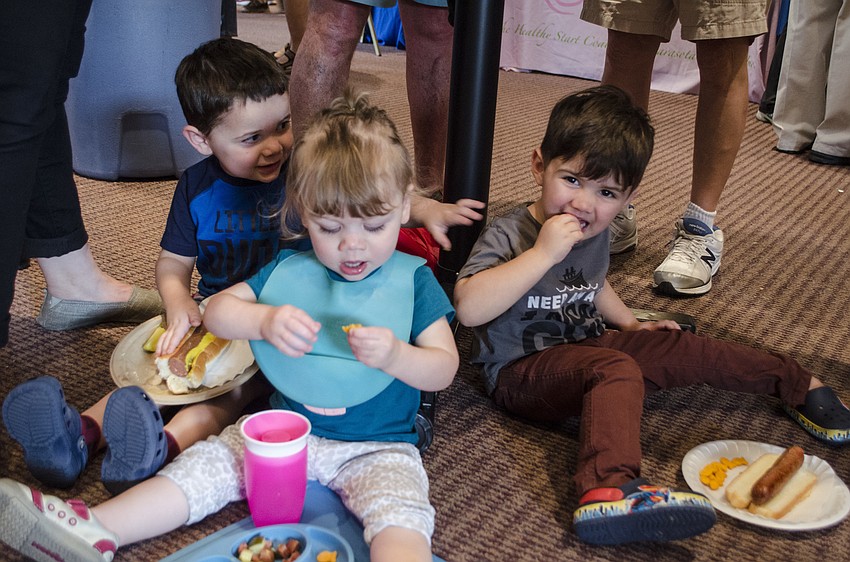 Maddox Kaplan, Kaelynn Kaplan and Noah Greber munch on hot dogs and Goldfish crackers.