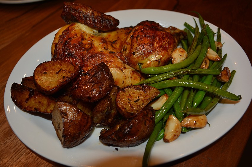 Rotisserie chicken and potatoes with green beans is one of the main events at Brasserie Honore.
