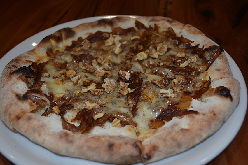 L'Alsacienne, a balsamic caramelized pizza with candied walnuts, will be a staple at Brasserie Honore.