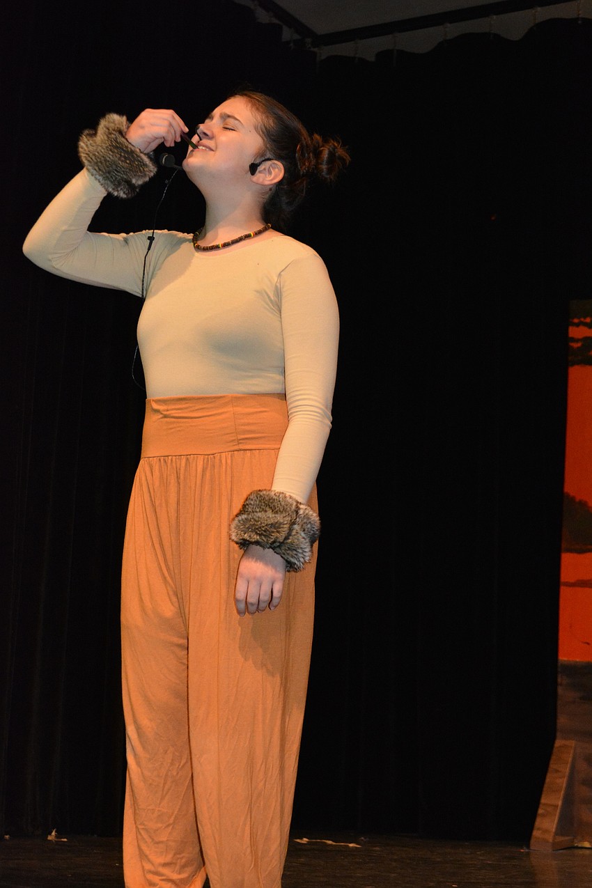 The young Simba, played by Sienna Zwizinski, samples a worm.