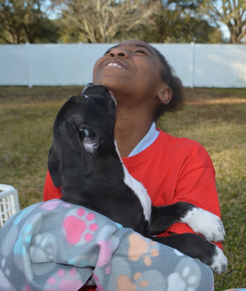Zhenasia Howard can't stop the puppy kisses from flowing.