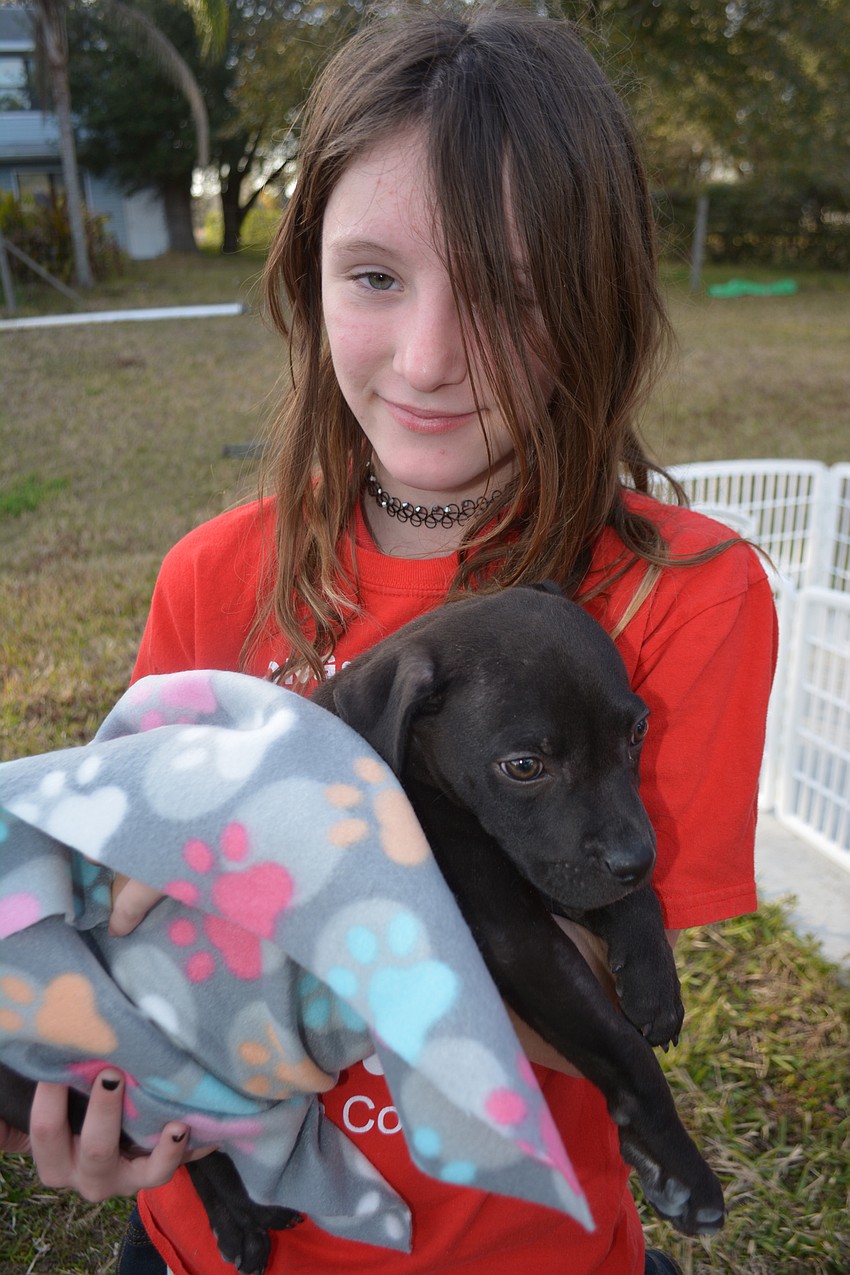 Jaylee Ortiz, 11, gets up close and personal with a Nate's resident.