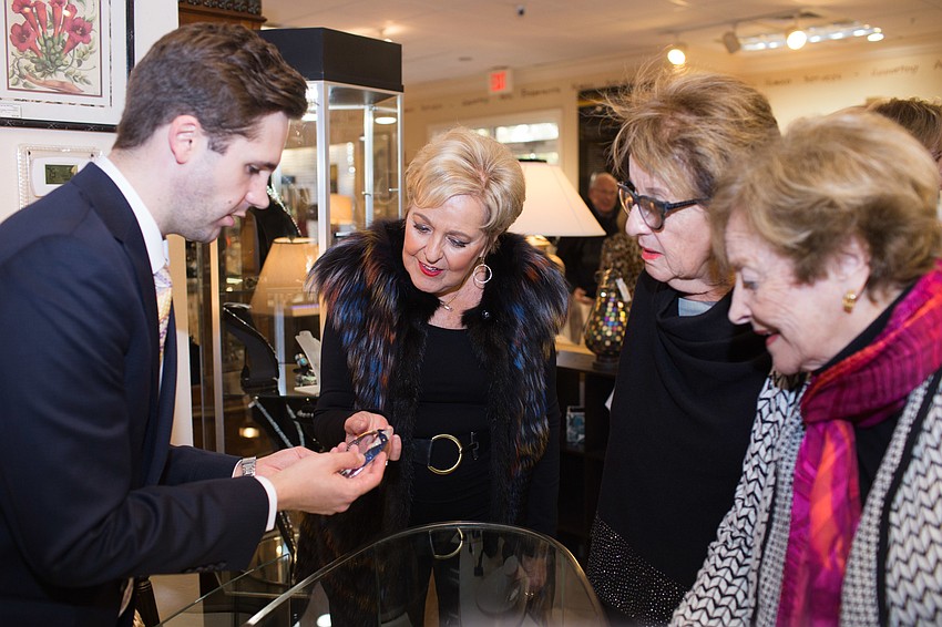 Ian Klopfer lets three ladies get up close and personal with a diamond bracelet.