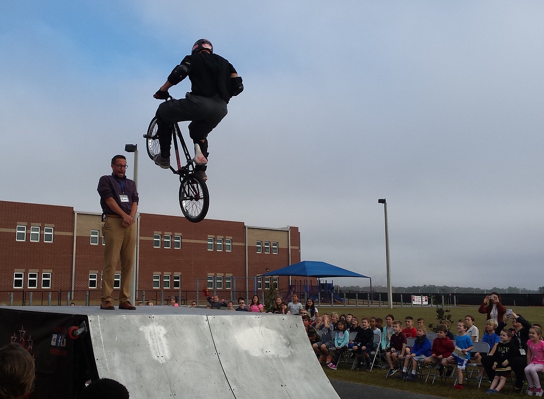 Principal Todd Richardson, of Gullett Elementary, takes a risk by letting a BMX rider jump him.