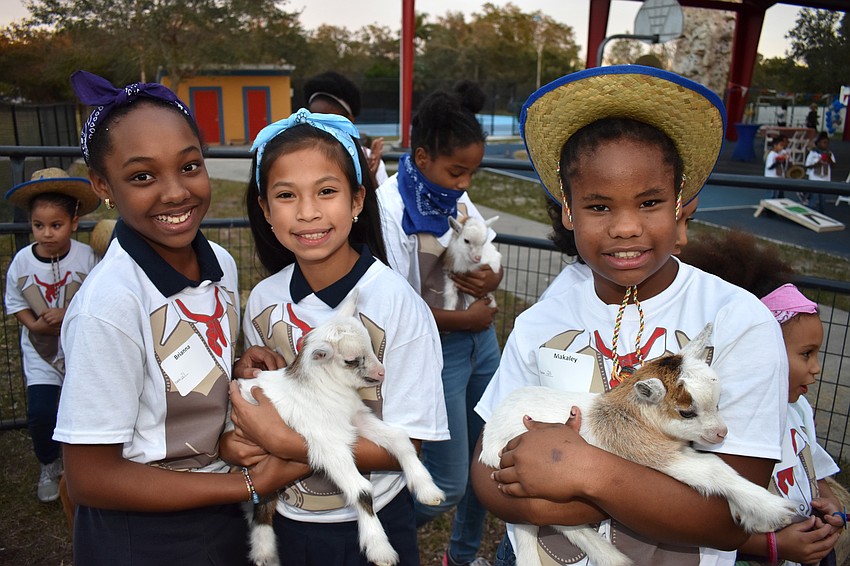 Club members Brianna, Melanie and Makaley make some new friends in the petting zoo.