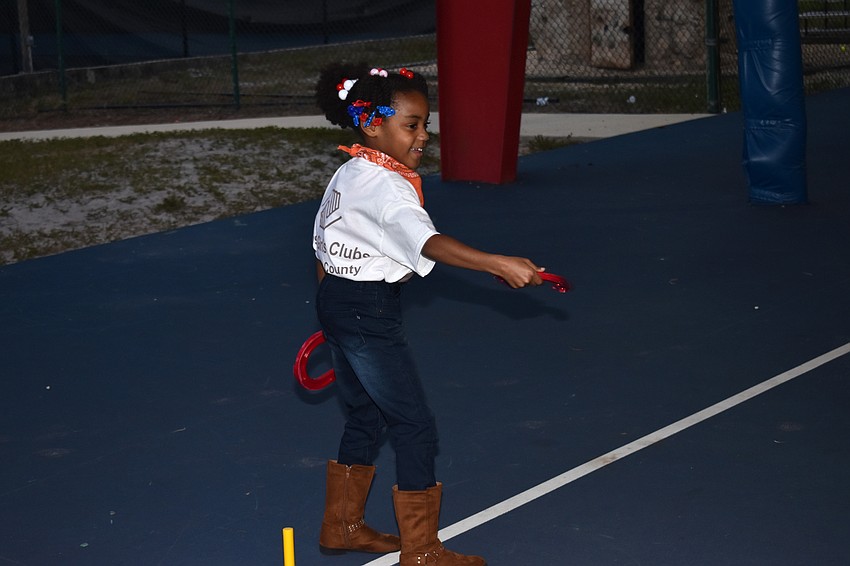 Club member Sade plays horseshoe ring toss.