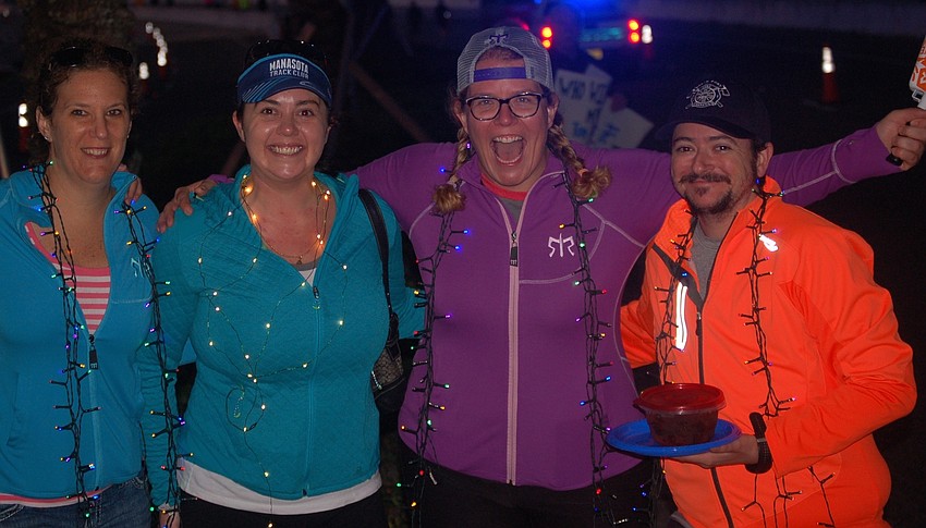Melissa Barber, Christine DeLeonardo, Kimmy Vanderveen and Louis Vanderveen posted themselves on the Ringling Bridge to cheer the runners.