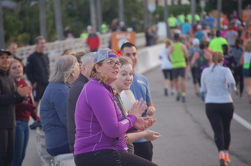 Kimmy Vanderveen cheers on the runners.