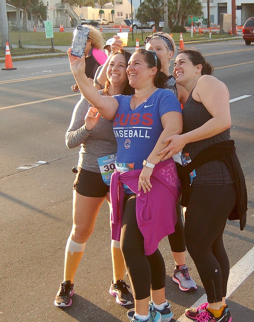 Randi Miller, Cyndi Rodriguez, Heather Flannery and Edy Attanasio stopped near the 10K finish for a photo.