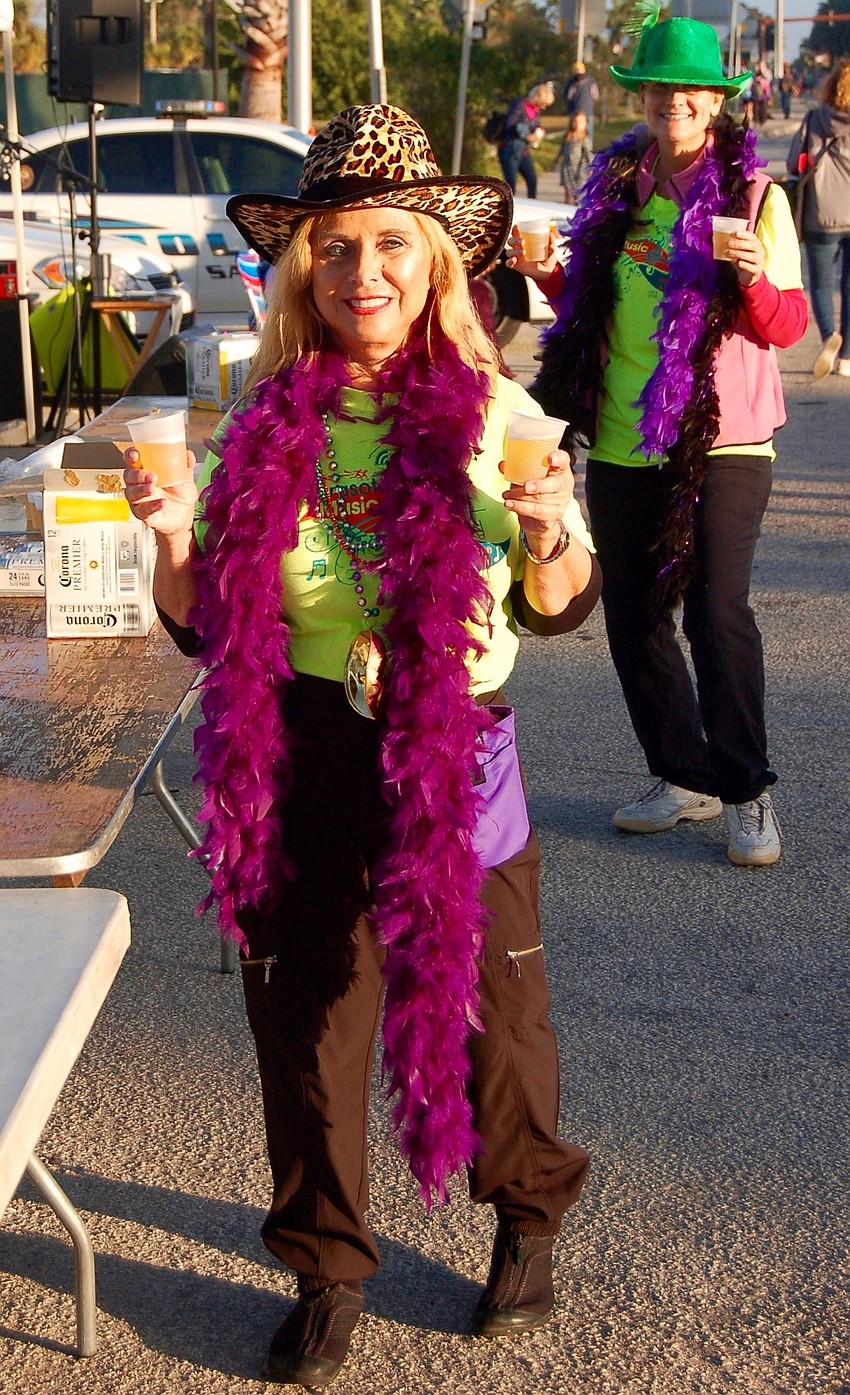 Janalee Heinemann was ready with beer for the runners near the conclusion of the race.