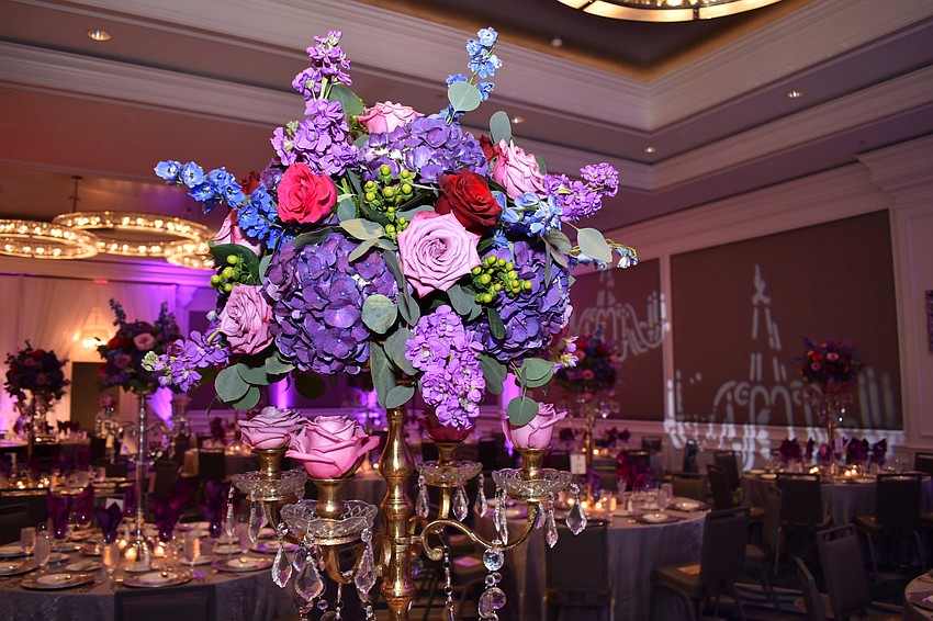 The ballroom was adorned with pink, purple and red flowers at Opera Gala.