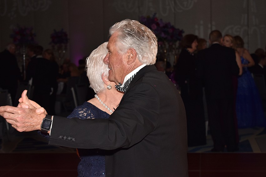 Carol and Les Brualdi dance before sitting down for dinner.