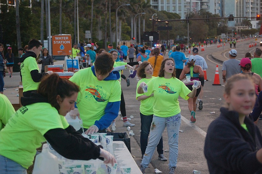 Race volunteers operate a water station at the eastern base of the Ringling Bridge.