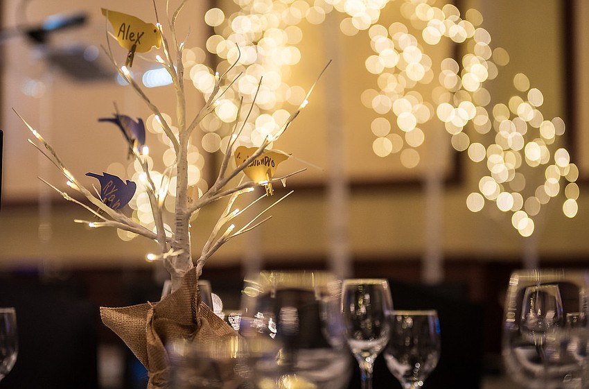 The centerpieces coordinated by Diana Roberts were birch trees with birds. The boys of Visible Men Academy each wrote their names on the birds.