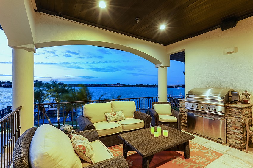 The outdoor seating area includes a summer kitchen.