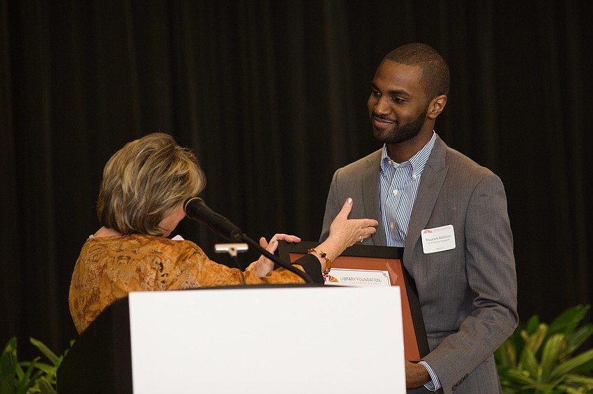 Sarabeth Kalajian awards the 2018 Literacy Champion honor to Maureik Robison.
