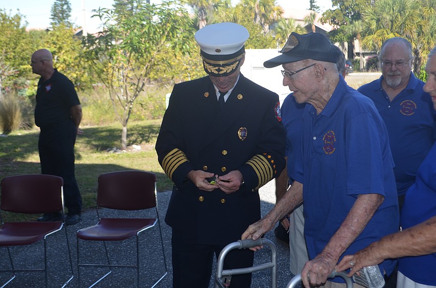 Michael Regnier receives the key to the department's new ATV from SKFAC Director Al Milner.