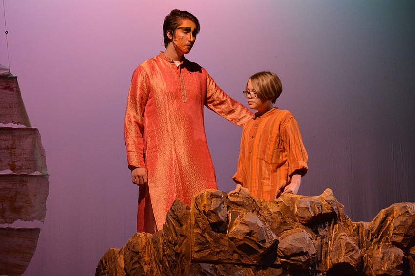 Mufasa, played by Ty Dearing, shares about his kingdom with his son, Simba, played by Ethan Hall.